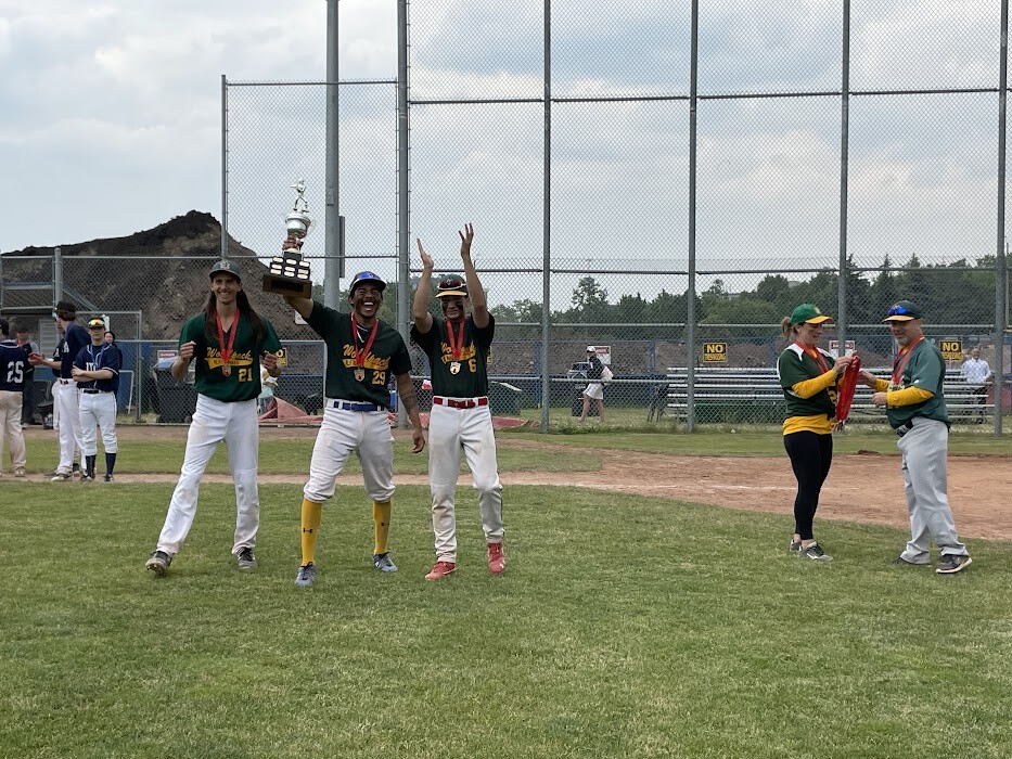Picture of 3 baseball players holding a trophy